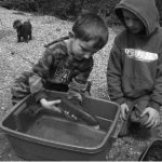 Ty Marasco holding his fish while Tyler Palmer looks on